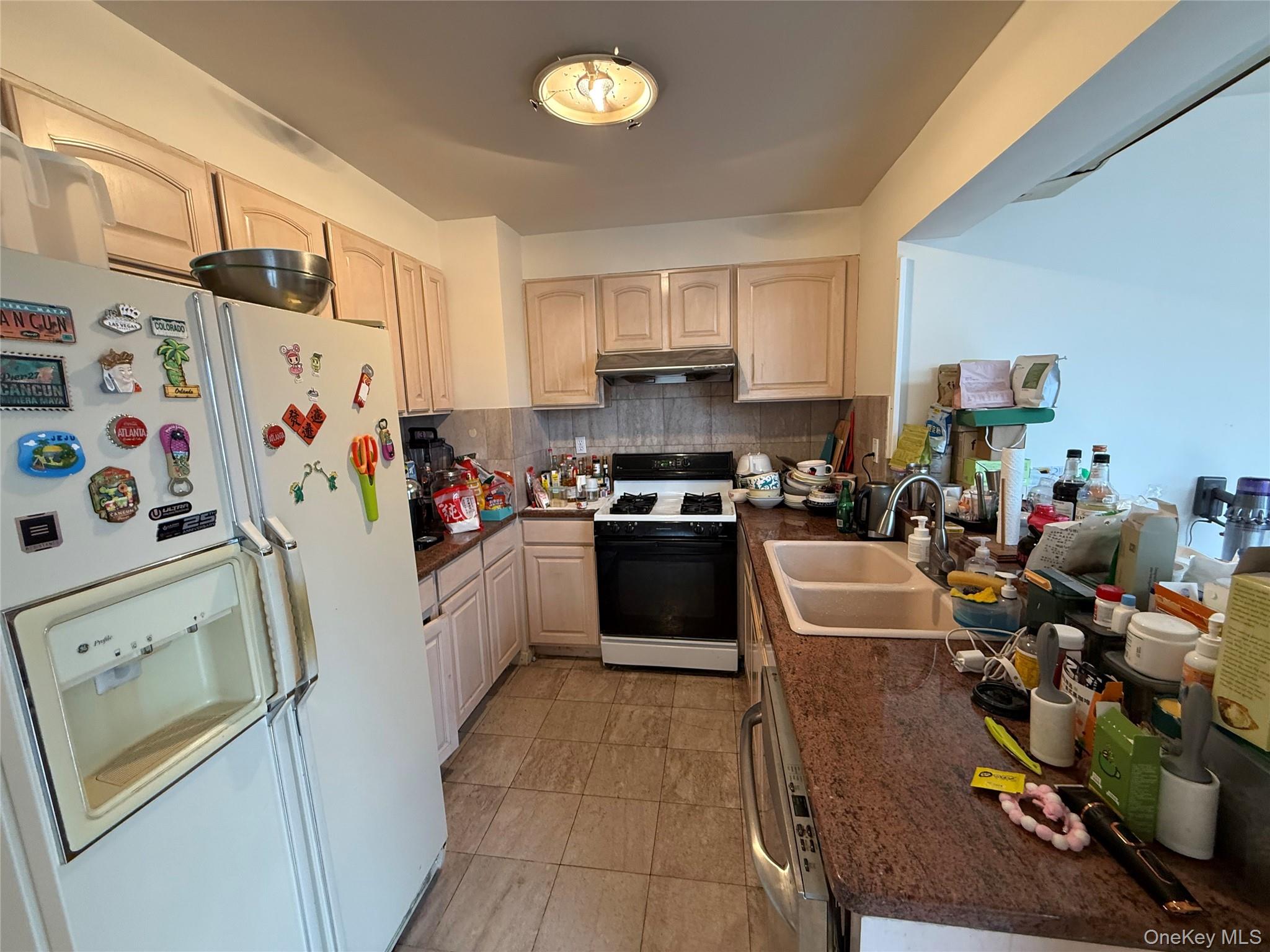 42-31 Colden Street, Unit F7A Queens, NY 11355 - Photo 8 of 18 a kitchen with a refrigerator a sink and a stove