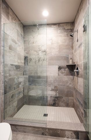 a bedroom with a bed and a large mirror