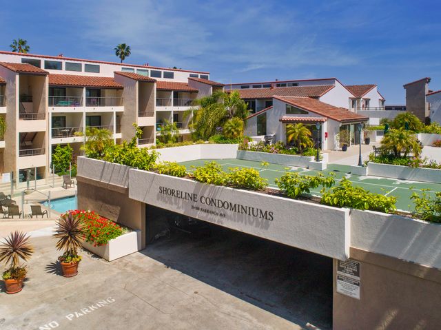 a view of a patio with couches table and chairs potted plants and palm tree