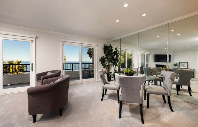a view of front door with potted plants in front of door