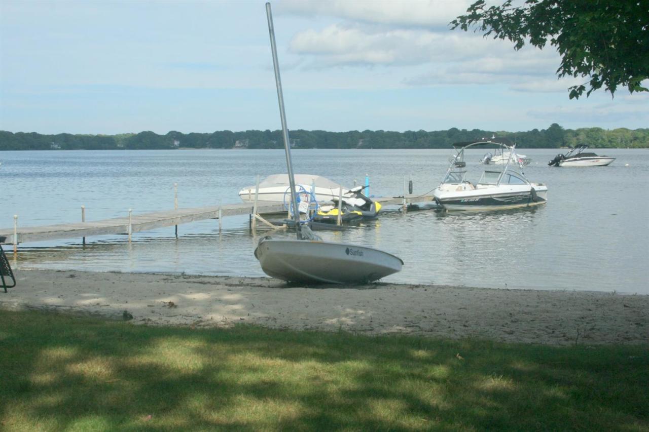 a view of a lake with boats and trees in the background