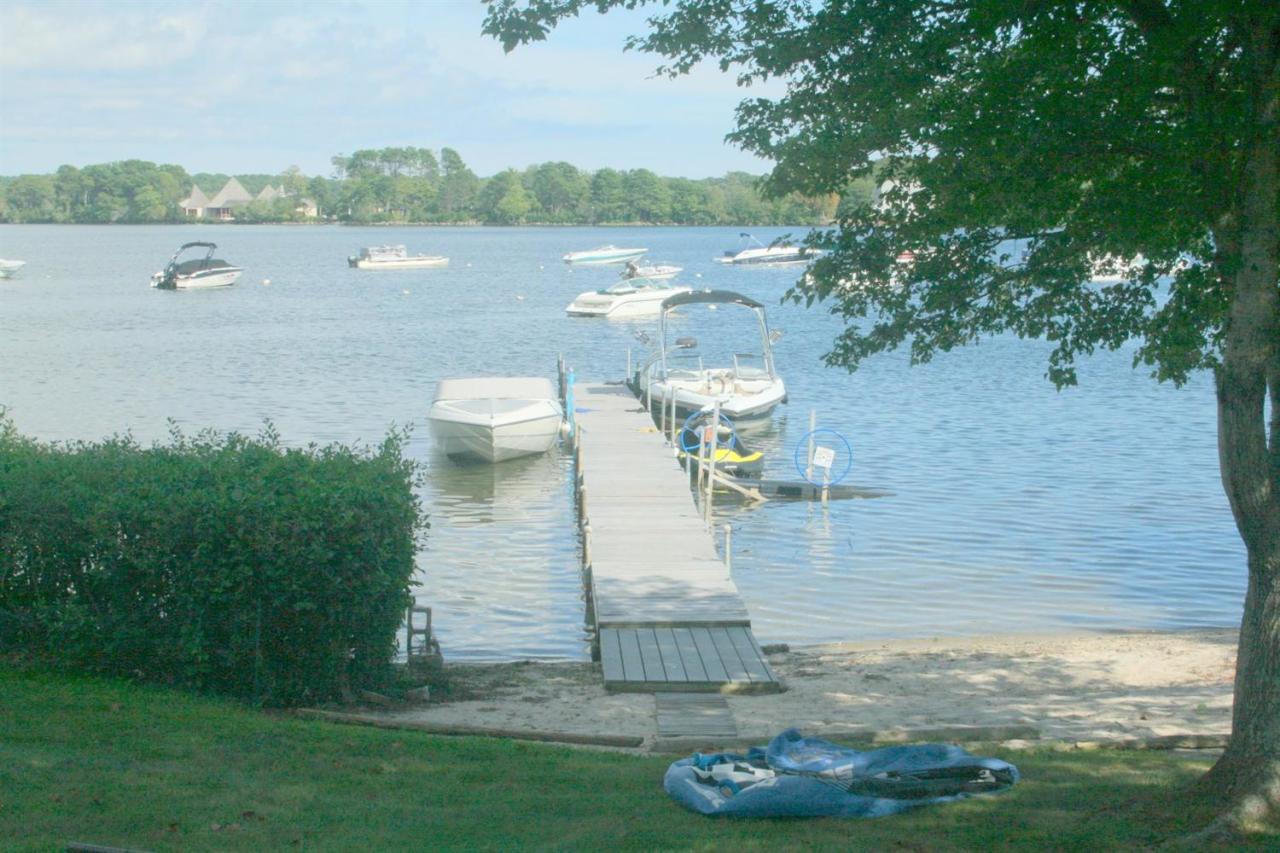 164 Annable Point Road Centerville, MA 02632 - Photo 7 of 13 a view of a lake with a yard and large trees