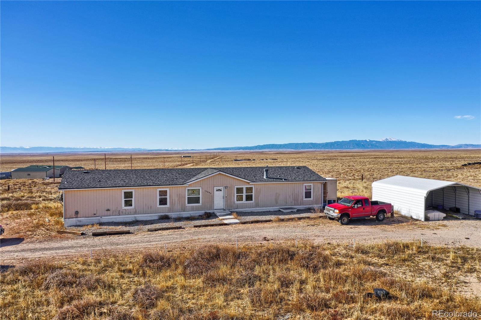 15840 South Lauppe Road Yoder, CO 80864 - Photo 1 of 22 a front view of a house with ocean view