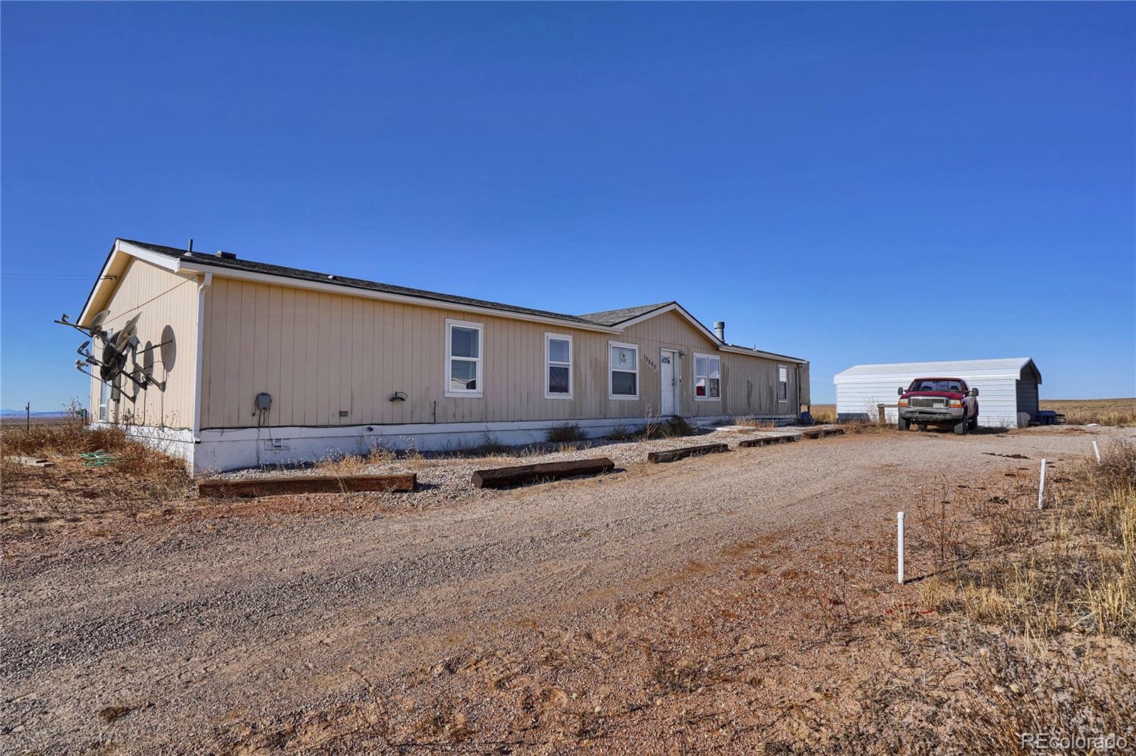 15840 South Lauppe Road Yoder, CO 80864 - Photo 9 of 22 a view of a car park in front of a house