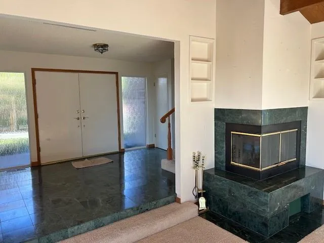 an empty room with closet and windows