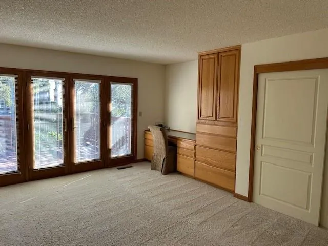 a view of a chair and table in the patio with potted plants