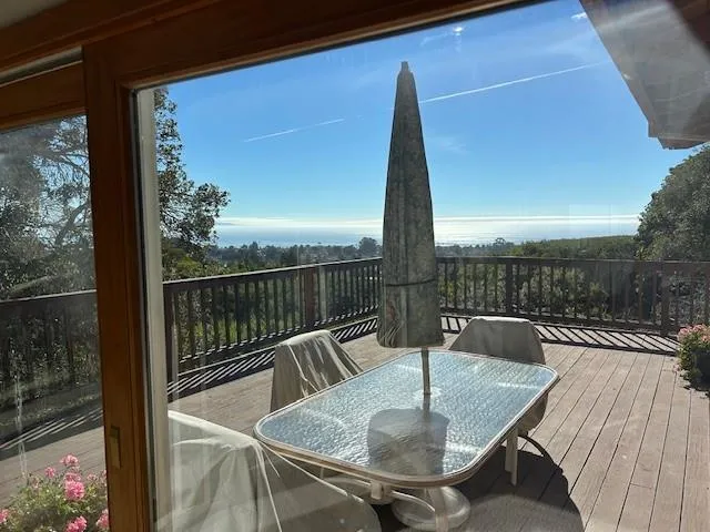 a view of a wooden deck with a table and chairs