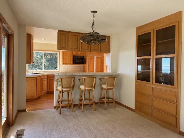 a kitchen with kitchen island a stove a sink and a refrigerator