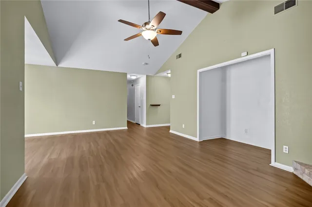 wooden floor in an empty room with a window