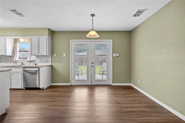 a view of a room with wooden floor bathroom and a window