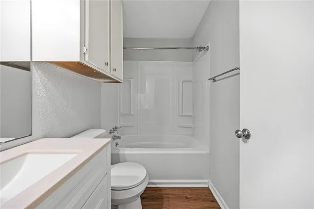 a bathroom with a granite countertop toilet sink and shower
