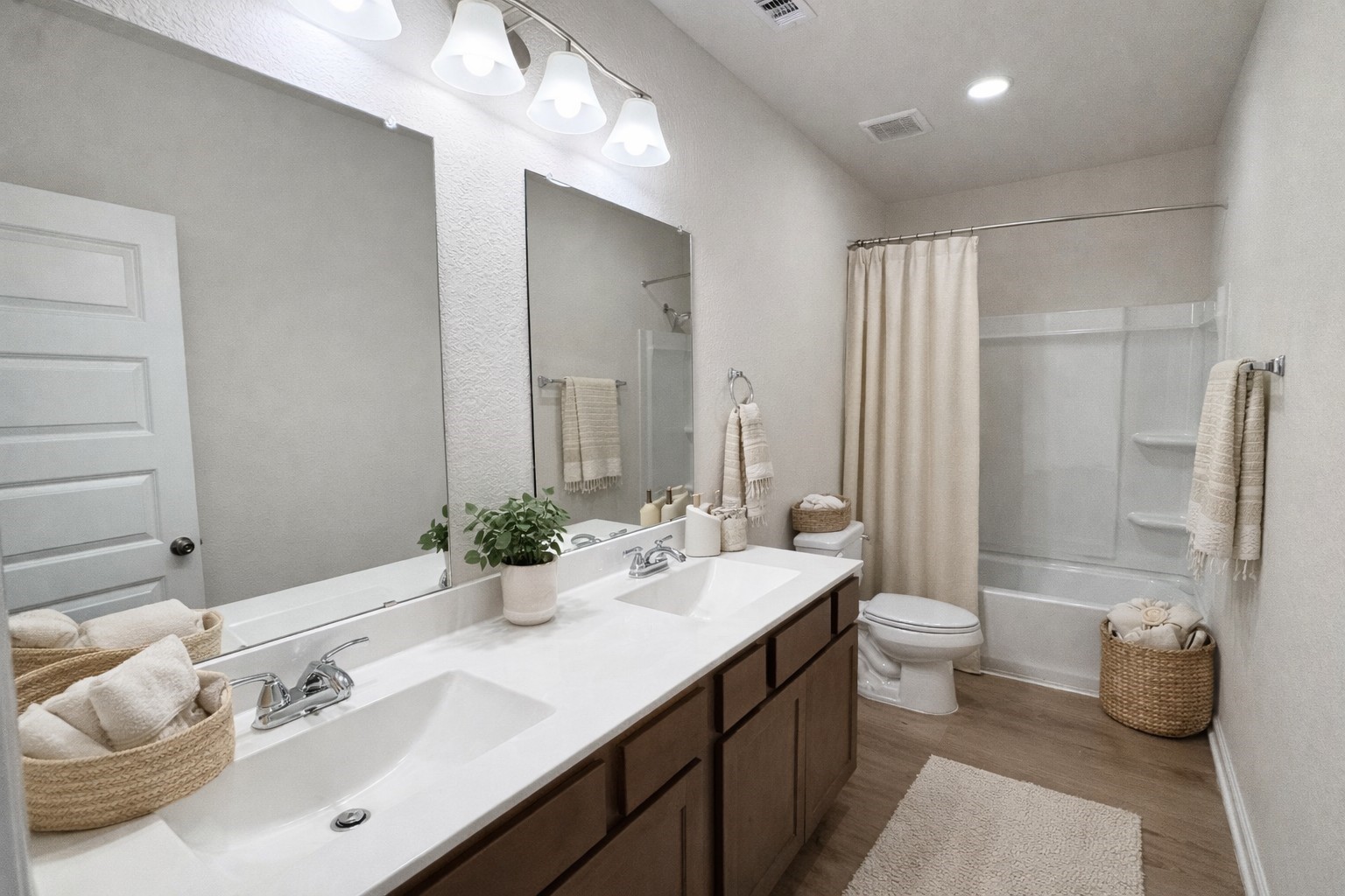 9749 Enclave Ridge Road Willis, TX 77318 - Photo 14 of 19 a bathroom with a double vanity sink toilet and a mirror