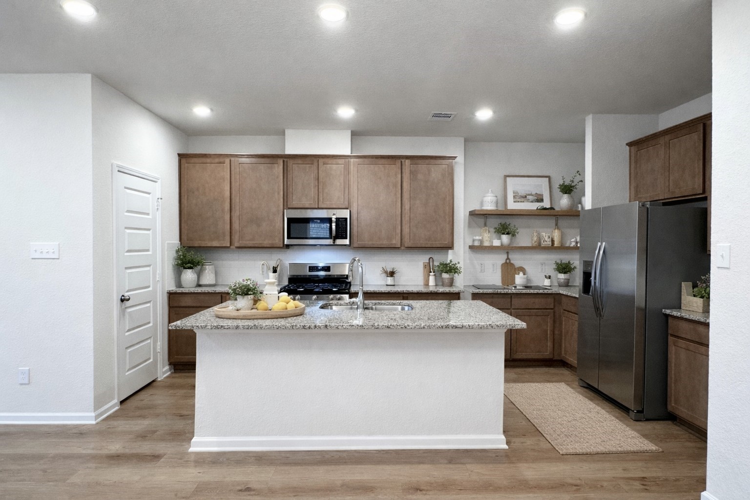9749 Enclave Ridge Road Willis, TX 77318 - Photo 6 of 19 a kitchen with stainless steel appliances granite countertop a refrigerator stove top oven and sink
