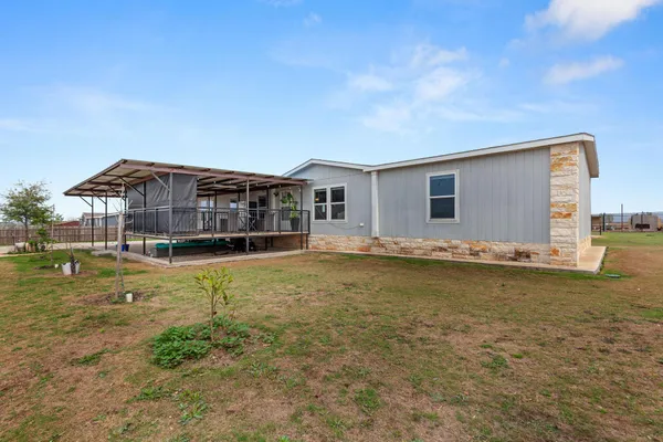 a view of a house with a backyard