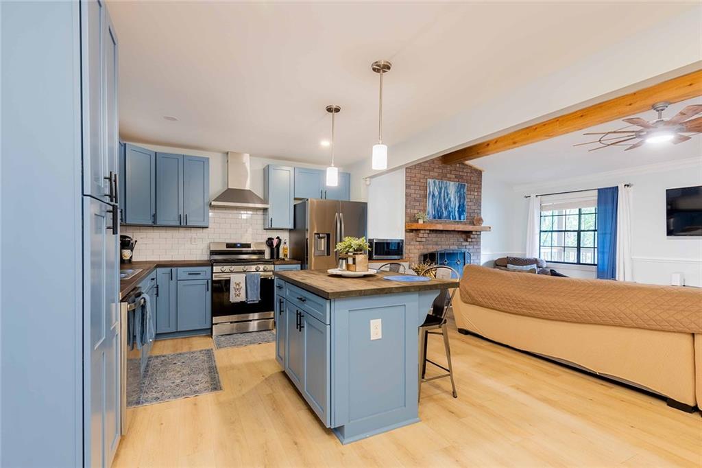 6375 Caladium Drive Acworth, GA 30102 - Photo 14 of 41 a kitchen with kitchen island a sink a counter top stainless steel appliances and cabinets
