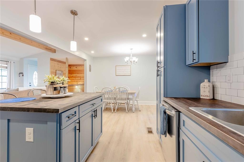 6375 Caladium Drive Acworth, GA 30102 - Photo 15 of 41 a kitchen with stainless steel appliances granite countertop a sink a stove and a wooden floors