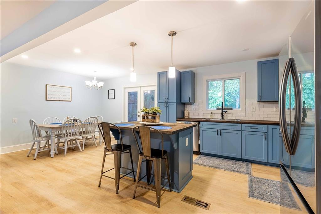 6375 Caladium Drive Acworth, GA 30102 - Photo 16 of 41 a kitchen with stainless steel appliances granite countertop a table chairs and a sink