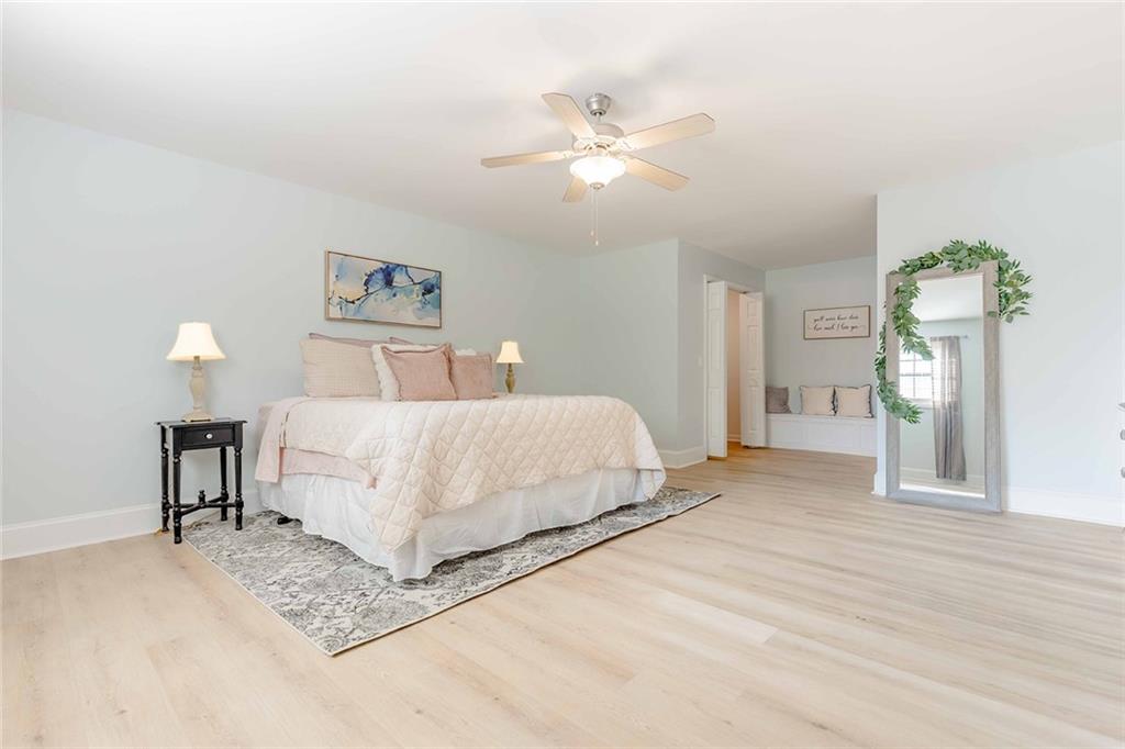 6375 Caladium Drive Acworth, GA 30102 - Photo 21 of 41 a spacious bedroom with a bed and a chandelier