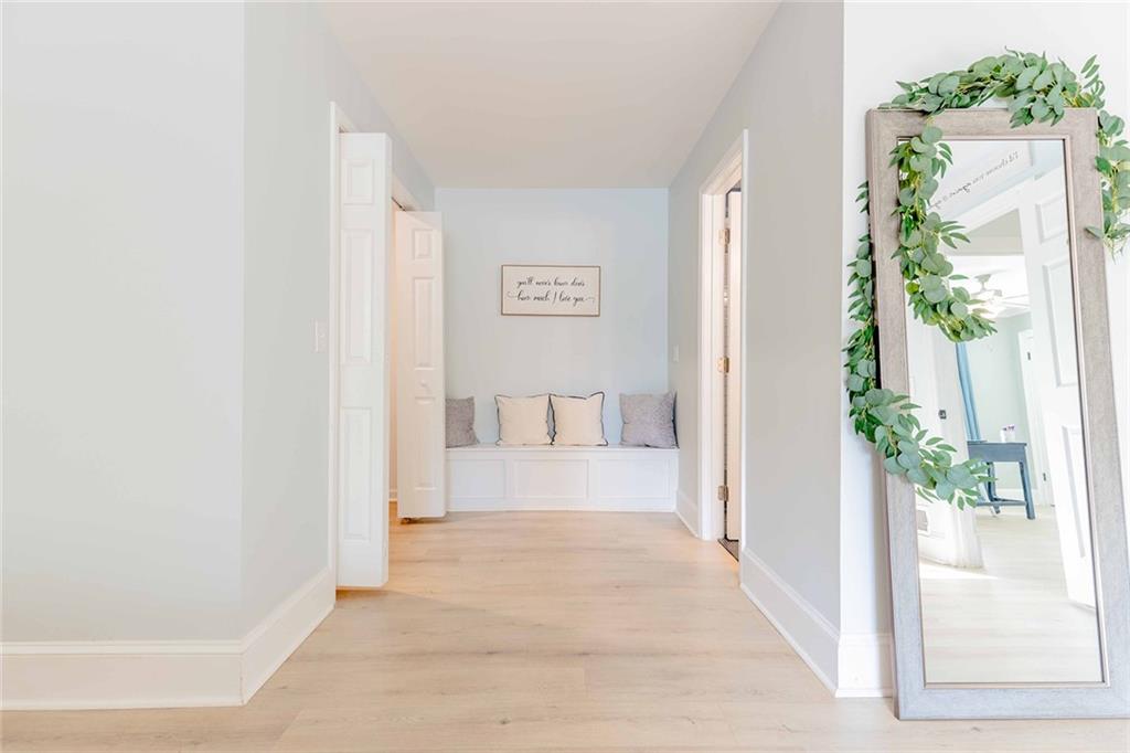6375 Caladium Drive Acworth, GA 30102 - Photo 22 of 41 a view of a hallway with wooden floor and a potted plant