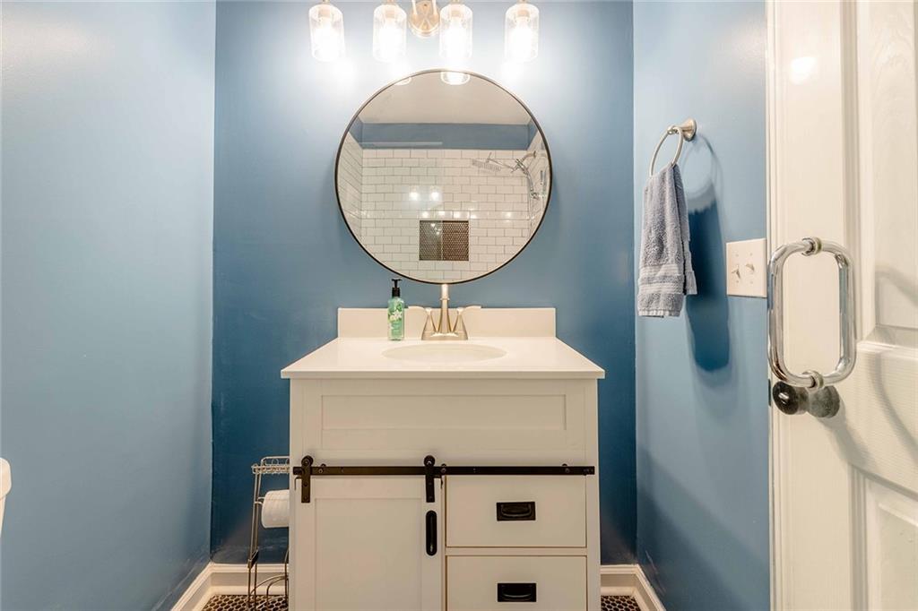 6375 Caladium Drive Acworth, GA 30102 - Photo 25 of 41 a bathroom with a sink and a mirror