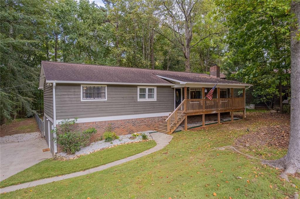 6375 Caladium Drive Acworth, GA 30102 - Photo 3 of 41 a view of a house with a yard balcony and wooden fence