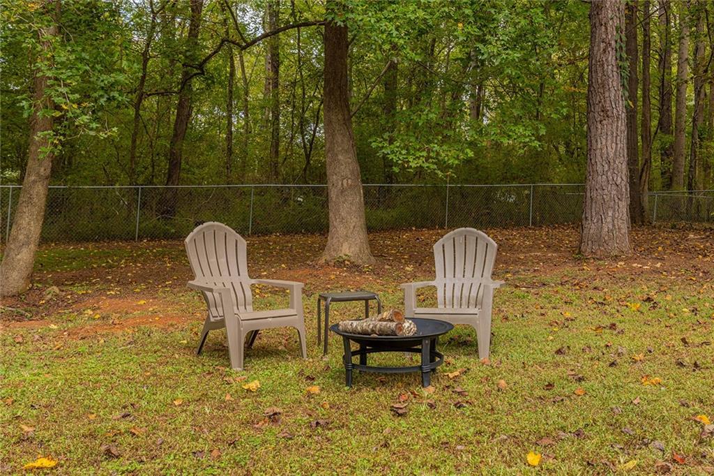 6375 Caladium Drive Acworth, GA 30102 - Photo 37 of 41 a wooden bench sitting in the middle of a yard