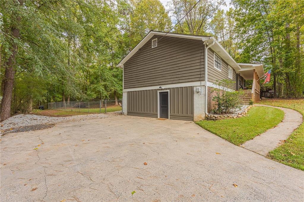 6375 Caladium Drive Acworth, GA 30102 - Photo 4 of 41 a view of a house with a yard and garage