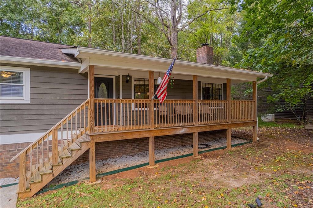 6375 Caladium Drive Acworth, GA 30102 - Photo 5 of 41 a view of a house with a small deck and a yard
