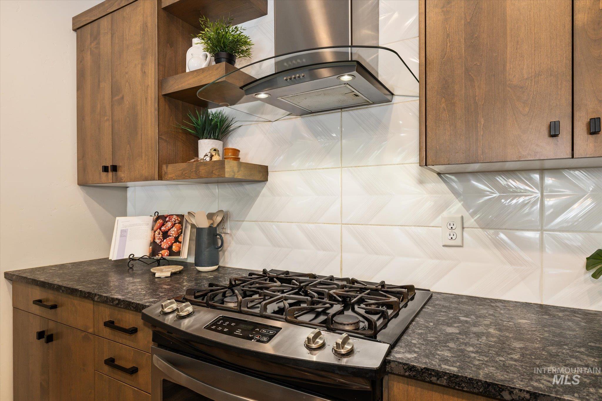 1915 South High Street Boise, ID 83706 - Photo 23 of 44 Kitchen featuring a stainless steel range with a gas cooktop, a coordinating stainless steel and glass range hood, and wood-finish cabinetry
