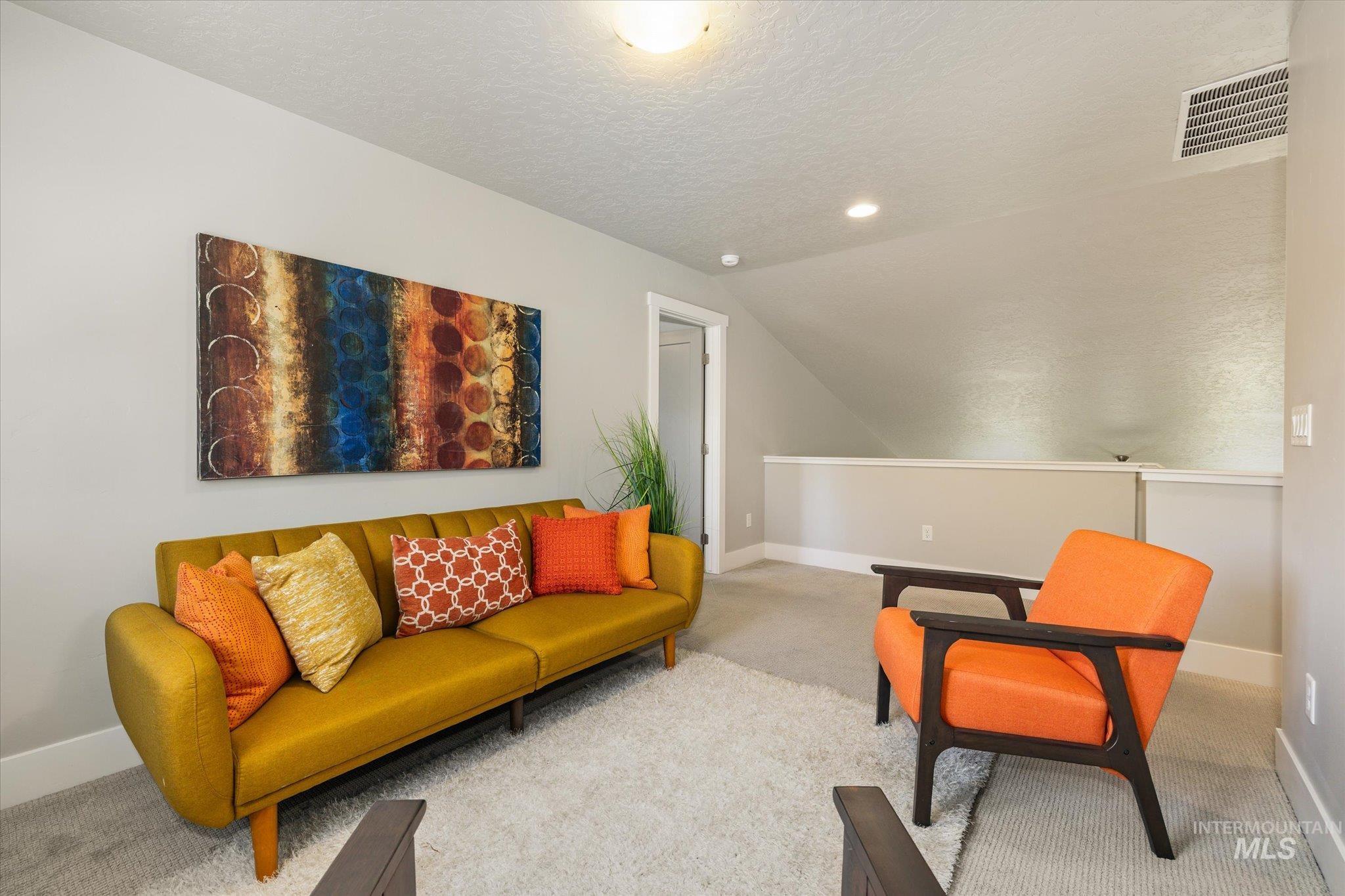 1915 South High Street Boise, ID 83706 - Photo 27 of 44 Carpeted loft area featuring a sloped ceiling and a white railing overlooking a lower level