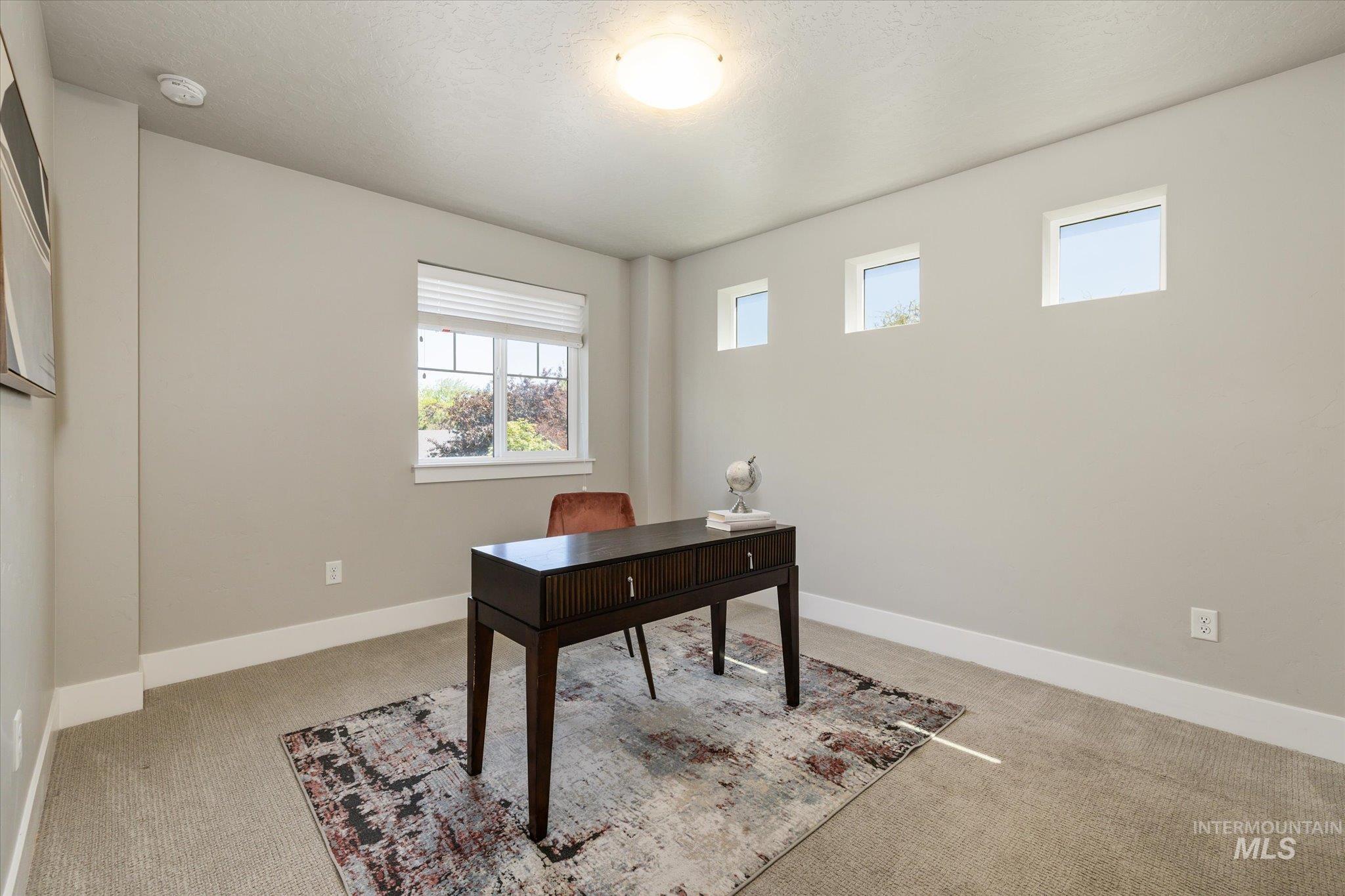 1915 South High Street Boise, ID 83706 - Photo 29 of 44 Neutral-toned room featuring a large window with white blinds and three transom windows