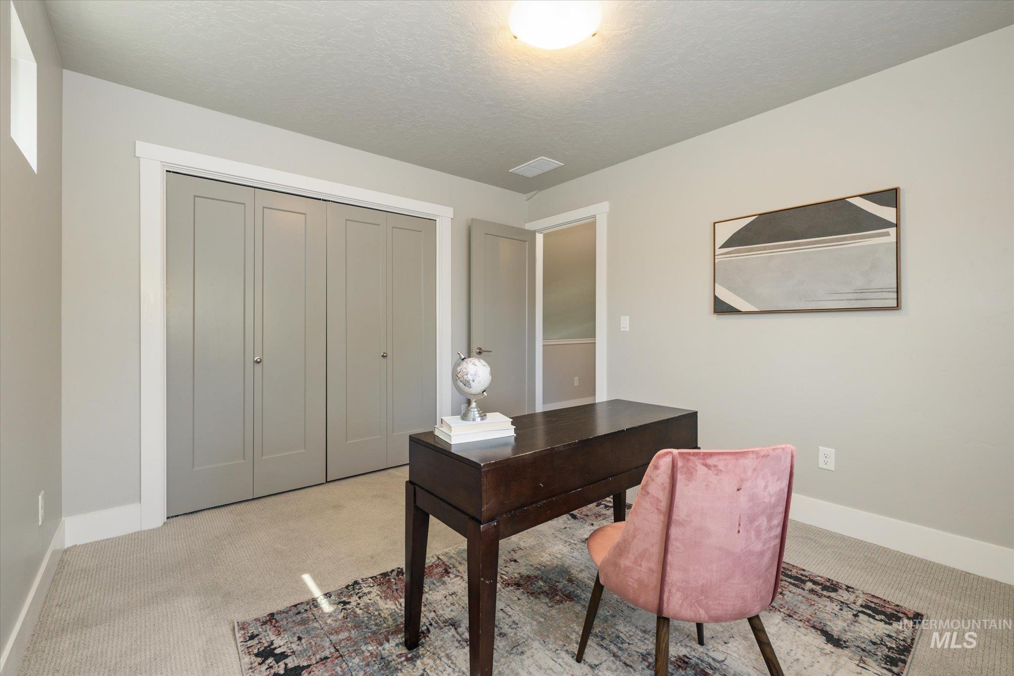 1915 South High Street Boise, ID 83706 - Photo 30 of 44 Interior room featuring light gray walls, a flush-mount ceiling light fixture, and light-colored carpet