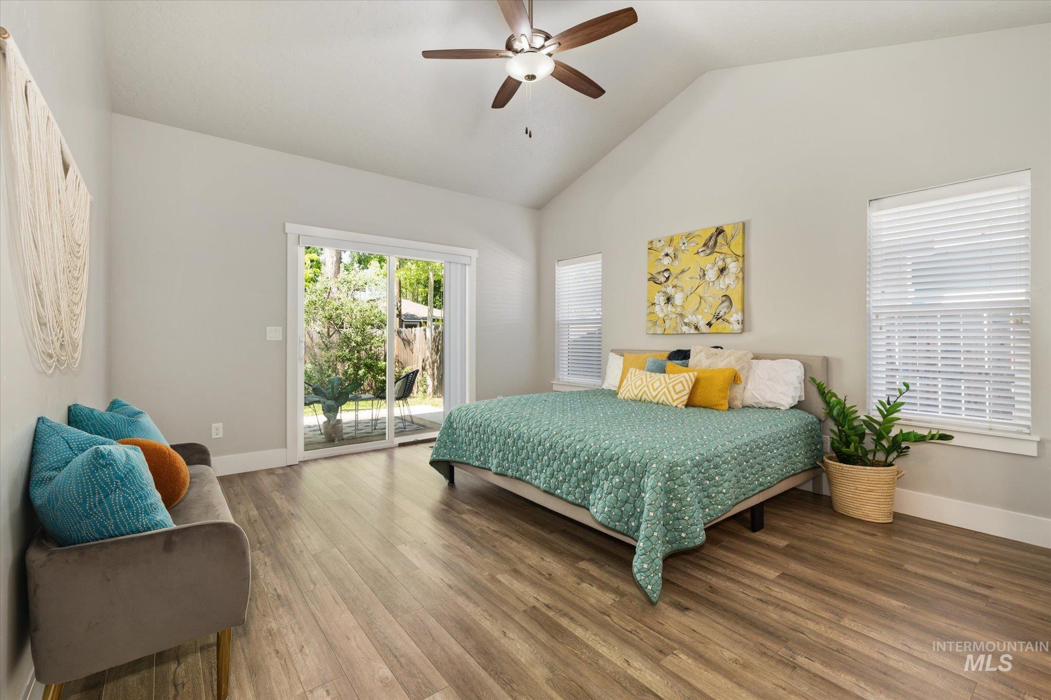 1915 South High Street Boise, ID 83706 - Photo 5 of 44 Vaulted ceiling bedroom with wood-finish flooring, a ceiling fan, and a glass slider
