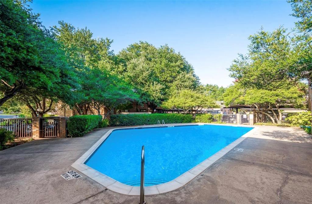 6026 Birchbrook Drive, Unit 119 Dallas, TX 75206 - Photo 12 of 13 a view of a swimming pool with an outdoor space and seating area