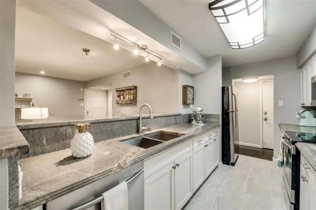 6026 Birchbrook Drive, Unit 119 Dallas, TX 75206 - Photo 5 of 13 a kitchen with a sink and refrigerator