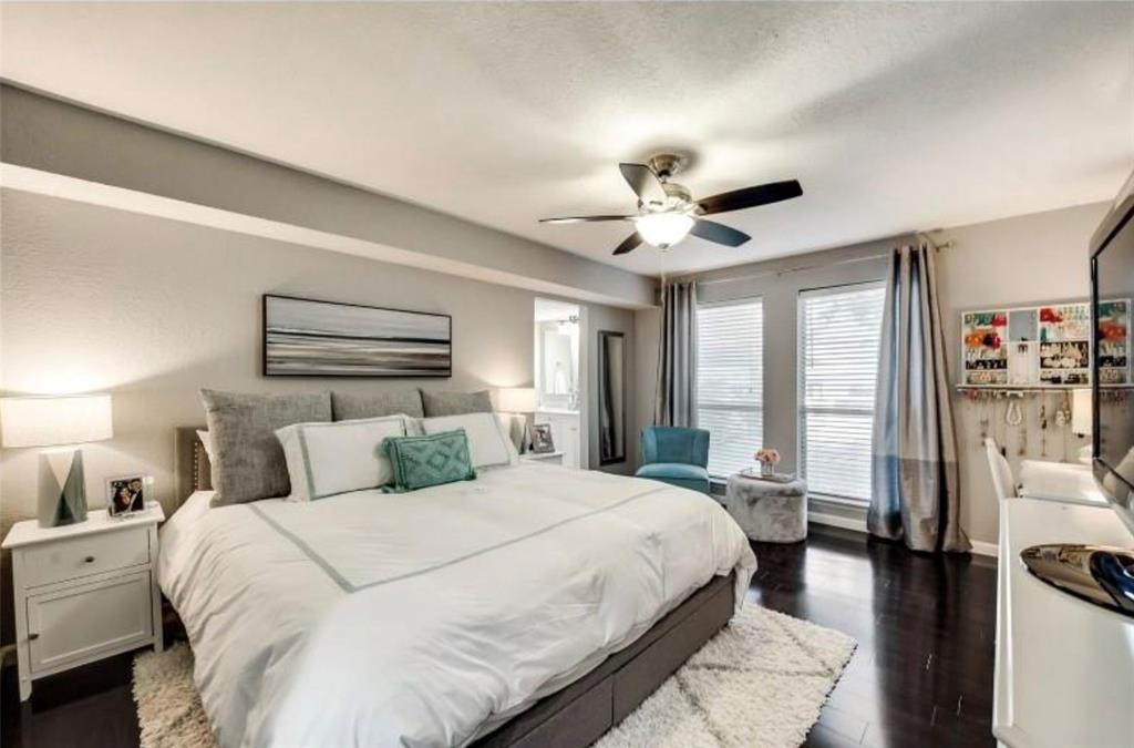 6026 Birchbrook Drive, Unit 119 Dallas, TX 75206 - Photo 7 of 13 a bedroom with a large bed and a chandelier