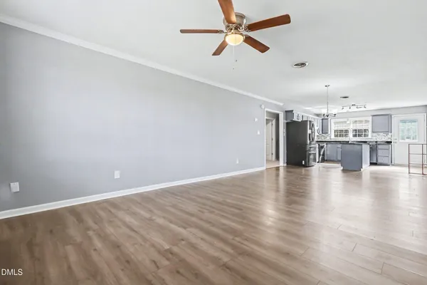 a view of a kitchen with a sink and a refrigerator