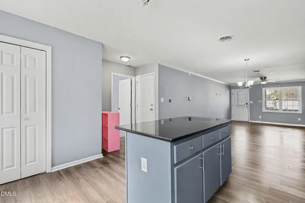a kitchen with a sink cabinets and wooden floor