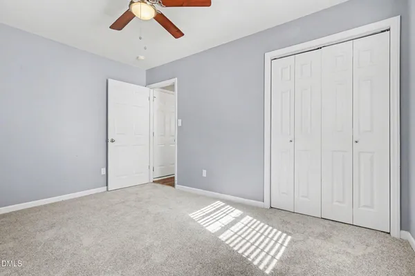 an empty room with a ceiling fan