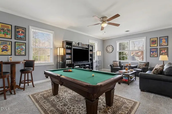 a room with furniture pool table and flat screen tv