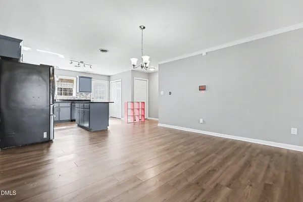 a view of a kitchen with a refrigerator a ceiling fan and wooden floor