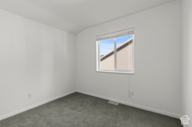 1099 Three Point Avenue Logan, UT 84321 - Photo 13 of 27 Unfurnished room featuring dark colored carpet and lofted ceiling