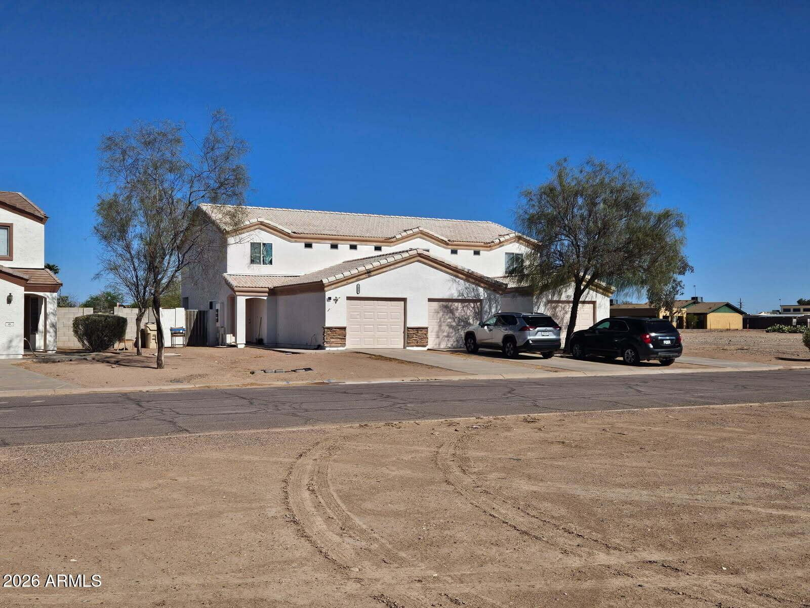 14097 South Berwick Road, Unit C Arizona City, AZ 85123 - Photo 1 of 8 a view of a car parked on the side of a street