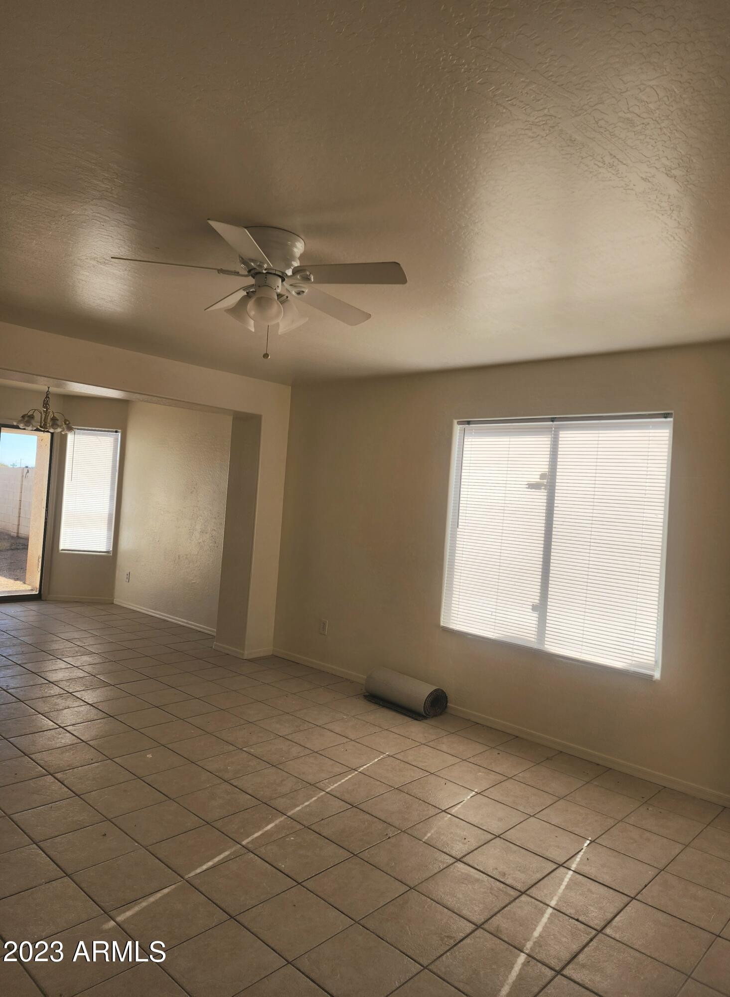 14097 South Berwick Road, Unit C Arizona City, AZ 85123 - Photo 2 of 8 an empty room with windows and fan