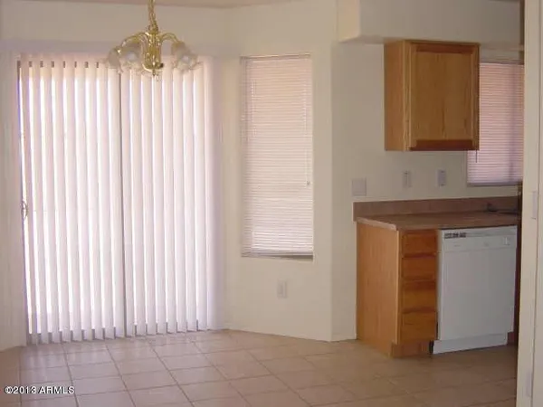 a view of a kitchen with wooden floor and a cabinet