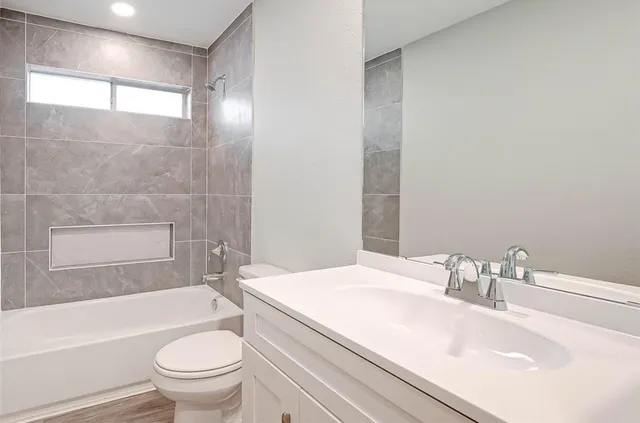 a bathroom with a sink toilet and shower