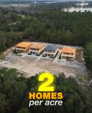 an aerial view of a swimming pool with outdoor seating