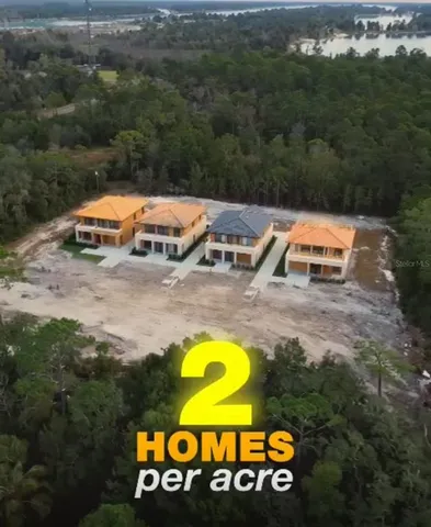 an aerial view of a swimming pool with outdoor seating