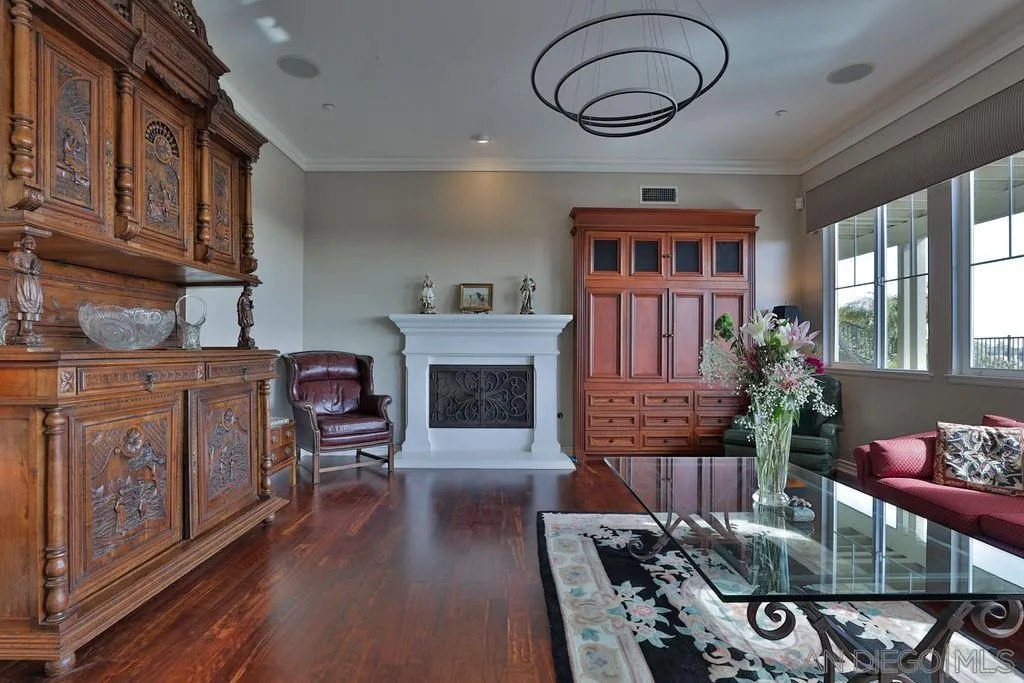 1375 Ravean Court Encinitas, CA 92024 - Photo 29 of 73 a living room with furniture a fireplace and wooden floor