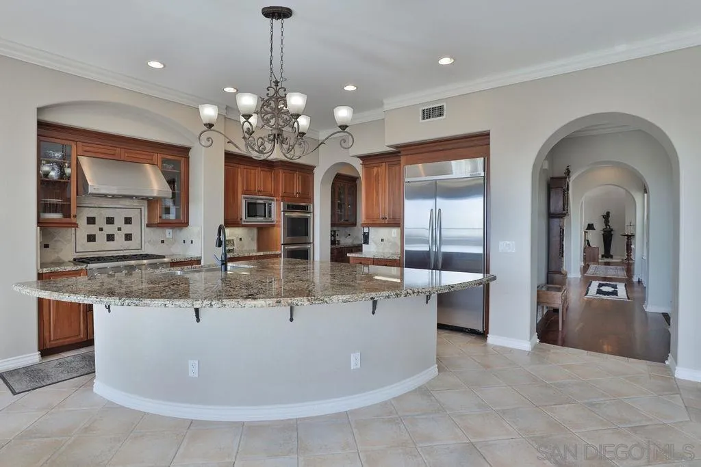 1375 Ravean Court Encinitas, CA 92024 - Photo 30 of 73 a view of living room with kitchen island granite countertop furniture and fireplace